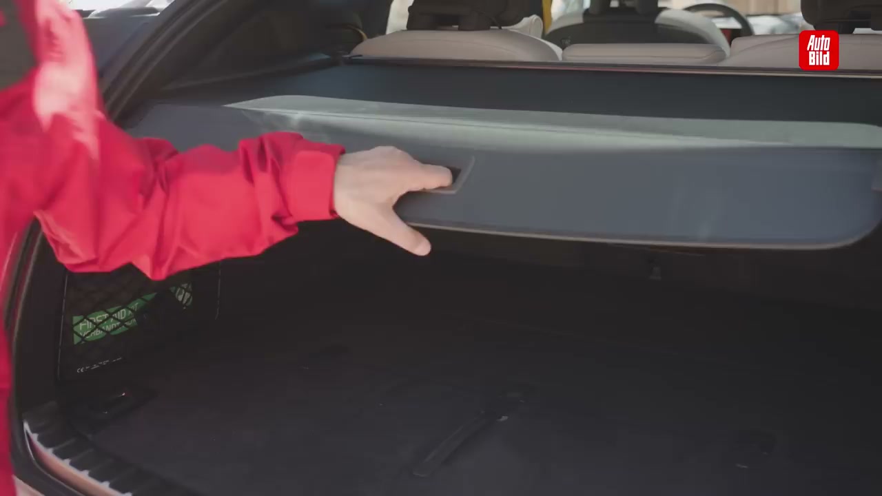 Hidden cargo area beneath main trunk floor - Demonstrating carry-on trolley fitting in sub-trunk
